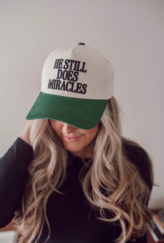 He Still Does Miracles Trucker Hat